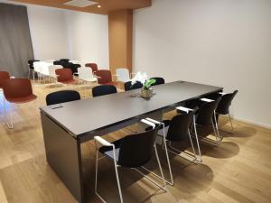 einen Konferenzraum mit einem Tisch und Stühlen in der Unterkunft Domo Apuliae Aparthotel in Bari