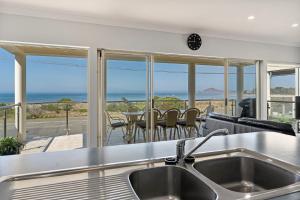 a kitchen with a view of the ocean at Esplanade Beachfront Victor Harbor in Victor Harbor