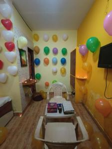a room with balloons on the wall and a table at Bluestar cottage in Matheran