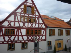 a half timbered house with a red roof at Landgasthof Zum Hasen in Kleinwallstadt