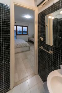 a bathroom with a sink and a bed in a room at Eur - Penthouse in Rome