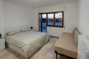 a bedroom with a bed and a window at Eur - Penthouse in Rome