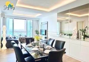 a dining room with a table and chairs at The Shore l 3BR l 6-11pax l 23A07 l Direct Access to Mall l JonkerSt l Melaka River View l City Centre by Jay Stay Management in Malacca