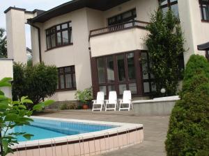 a house with a swimming pool in front of it at House Marija in Vilnius
