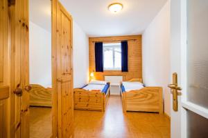 a small room with two beds and a window at Appartment 1500 m an der Seilbahnstation in Uttendorf