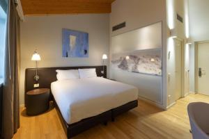 En eller flere senge i et værelse på Boiardo Hotel