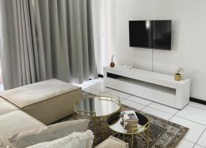 a living room with a couch and a tv at Place to remember in Sandton