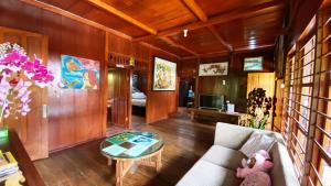 a living room with a couch and a table at rumah kayu sulawesi antique in Bedugul