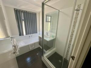 a bathroom with a shower and a sink at Quiet Busselton Retreat in Busselton +15 photos