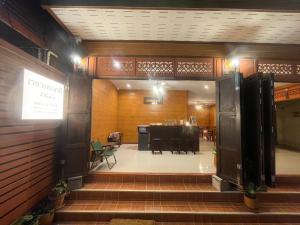 an entrance to a restaurant with a table and chairs at เวลาและนาที Wella&Natee in Chiang Khan