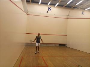 a man standing in a gym with a racket at Fortune Home Service Apartment 2Bhk,E28 Saket 2A in New Delhi