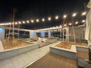 a patio at night with lights on a building at HOTEL THE DESIGNERS LYJ SUITE YEOKSAM in Seoul