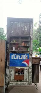 an old ice box with a drink in it at สามชุกบ้านสวน in Sam Chuk