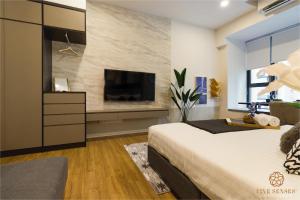 a bedroom with a bed and a tv on a wall at Ceylonz Suite, Bukit Bintang, Experience in Kuala Lumpur