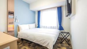 Postel nebo postele na pokoji v ubytování Toyoko Inn Yokohama-eki Nishi-guchi