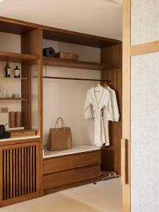 a wardrobe with a white robe and a purse at The Retreat, Koh Chang in Ko Chang