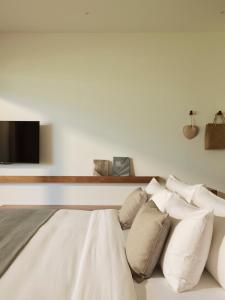 a bedroom with a bed with white pillows at The Retreat, Koh Chang in Ko Chang