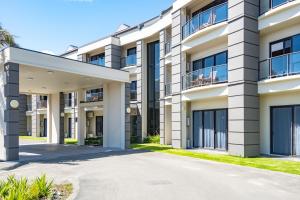 an image of an apartment building with a driveway at Portside Hotel Gisborne in Gisborne