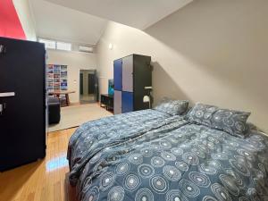 a bedroom with a large bed and a living room at Port Lincoln Studio Apartments in Port Lincoln