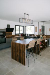 a kitchen with a large wooden table and chairs at La Dolce Vita Provençale Charming House with its Private Swimming Pool in L'Isle-sur-la-Sorgue