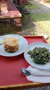 two white plates of food on a red table at Hause market in Sidemen