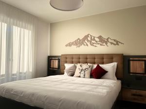 Postel nebo postele na pokoji v ubytování Hotel Rododendro Val di Fassa