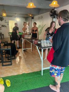 a group of people standing around a table with drinks at Blanco Central in Phi Phi Islands