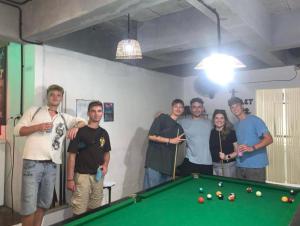 a group of people standing around a pool table at Blanco Central in Phi Phi Don