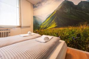 two beds in a room with a painting on the wall at Weideglück-Zentral-Dampfdusche in Oberstaufen