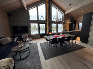 a large living room with a table and chairs at Vinterdröm Idre Himmelfjäll in Idre