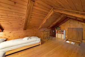 a bedroom with a bed in a wooden room at Appartamento La Fontaine Ski In Ski Out - Happy Rentals in Claviere