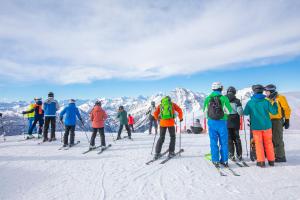 a group of people on skis in the snow at Appartamento La Fontaine Ski In Ski Out - Happy Rentals in Claviere