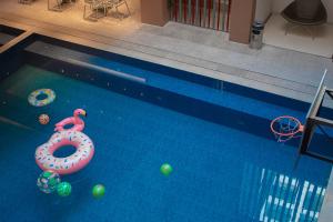 an overhead view of a swimming pool with a donut and balls at Valentino's Hotel in Angeles