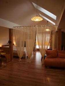 - un salon avec des rideaux blancs et un canapé dans l'établissement Haus Schober, à Windischgarsten
