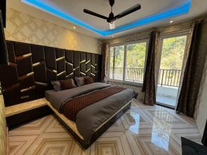 a bedroom with a bed and a ceiling fan at Rabha Stay 2BHK Penthouse with Terrace in Rishīkesh