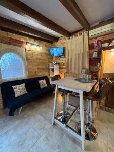 a living room with a blue couch and a table at Villa Paquita Loft in Deltebre
