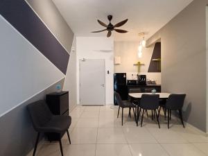 a dining room with a table and chairs and a ceiling fan at The Horizon Ipoh 2BR L11 by Grab A Stay in Ipoh