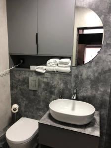 a bathroom with a sink and a toilet and a mirror at Небокрай in Palyanytsya +32 photos