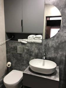 a bathroom with a sink and a toilet and a mirror at Небокрай in Palyanytsya