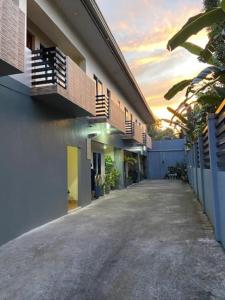 an empty alley between two buildings with a sunset at Estilo 2-Bedroom Apartment B in Clarin