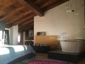 a bedroom with a large bed and a bath tub at B&B con SPA il Castello di Lucawest in Ponteranica