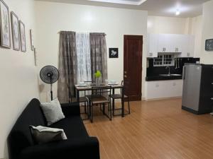 a living room with a couch and a table and a kitchen at Estilo 2-Bedroom Apartment B in Clarin