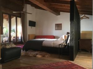 a bedroom with a bed and a dog laying on the floor at B&B con SPA il Castello di Lucawest in Ponteranica