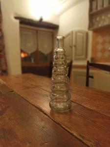 a glass bottle sitting on top of a wooden table at Appartement de campagne à Limans in Limans