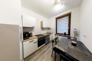 a small kitchen with a table and a dining room at Apartment Tea in Triberg