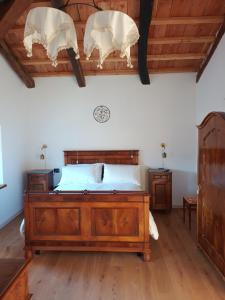 a bedroom with a bed with antlers on the wall at La Farie in Mediis