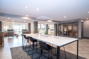 a large dining room with a table and chairs at Sandman Hotel Calgary Airport in Calgary