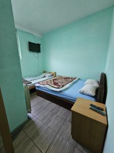 a small room with two beds and a table at Guesthouse Meče in Bijelo Polje