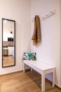 a white bench in a room with a mirror at Bari incanto - 3 Bedroom Apartment & Free Parking in Bari
