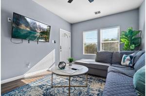 a living room with a couch and a table at Step into Comfort in this 3BR2BA Downtown Retreat in San Antonio
